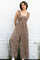 woman wearing a brown floral print jumpsuit with ruffled straps and wide legs