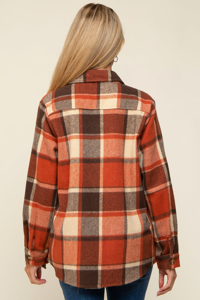 woman wearing a red, brown, and cream plaid maternity flannel shirt, shown from the back