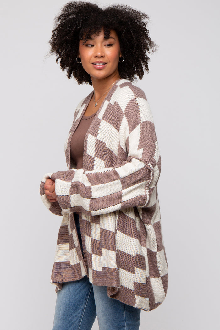 woman wearing a brown and cream plaid oversized cardigan with long sleeves and a relaxed fit