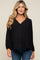 woman wearing a black maternity top with a v-neck and long sleeves