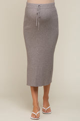 woman wearing a grey ribbed maternity midi skirt with drawstring waist and white flip flops