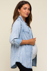 woman wearing a light blue denim maternity shirt, showing a baby bump and styled with rolled-up sleeves