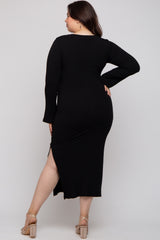 woman wearing a black ribbed maternity plus dress with long sleeves and a side slit, viewed from the back