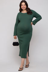 woman wearing a green ribbed maternity dress with long sleeves and a side slit, holding a black handbag and showing her baby bump