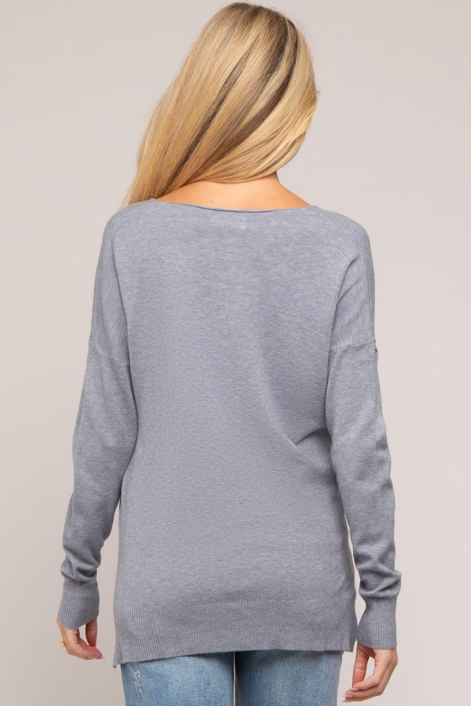 woman wearing a gray long sleeve maternity sweater, styled with a relaxed fit, showing the back view