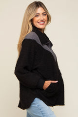 woman wearing a black and gray maternity pullover fleece jacket with side pockets and a stand-up collar