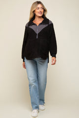 woman wearing a black and gray color block half zip maternity pullover with a relaxed fit and blue jeans