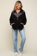 woman wearing a black and gray half-zip fleece maternity pullover with a front pocket, paired with light blue jeans