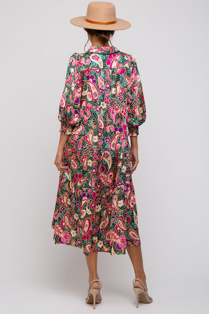 woman wearing a colorful paisley print maternity dress with balloon sleeves and a flattering silhouette