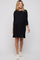 woman wearing a black elbow sleeve maternity dress with side slits and visible baby bump