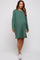 woman wearing a green long sleeve maternity dress with a relaxed fit and a visible baby bump