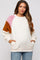 woman wearing a cream and multi-colored maternity fleece pullover with pockets and long sleeves, baby bump visible