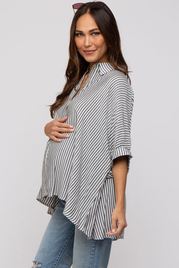 woman wearing a grey and white striped maternity top and holding her baby bump