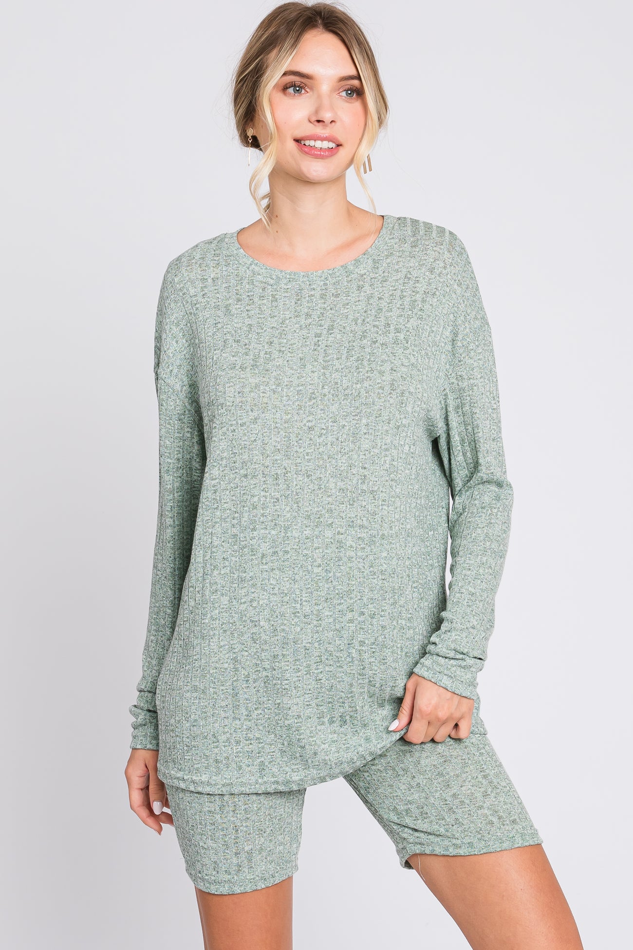 woman wearing a light green long sleeve ribbed loungewear top and matching shorts