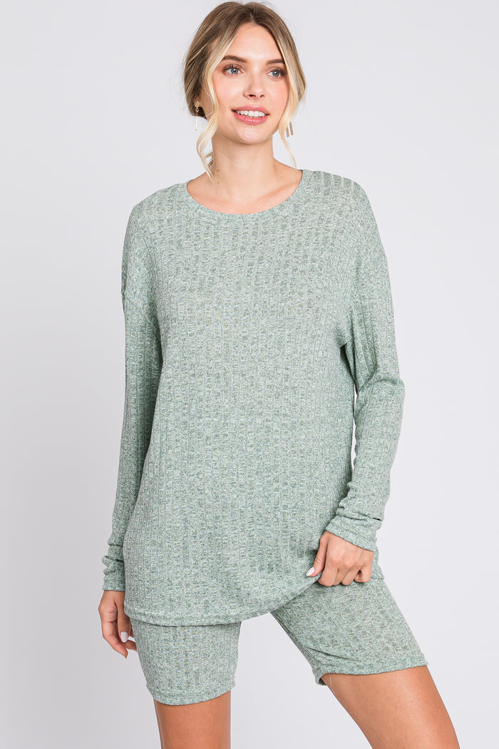 woman wearing a light green long sleeve ribbed loungewear top and matching shorts
