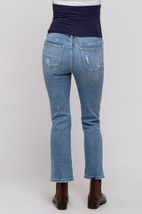 woman wearing light blue maternity jeans with a distressed design and bootcut style, viewed from the back