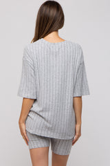 woman wearing a gray ribbed maternity top and matching shorts, viewed from the back