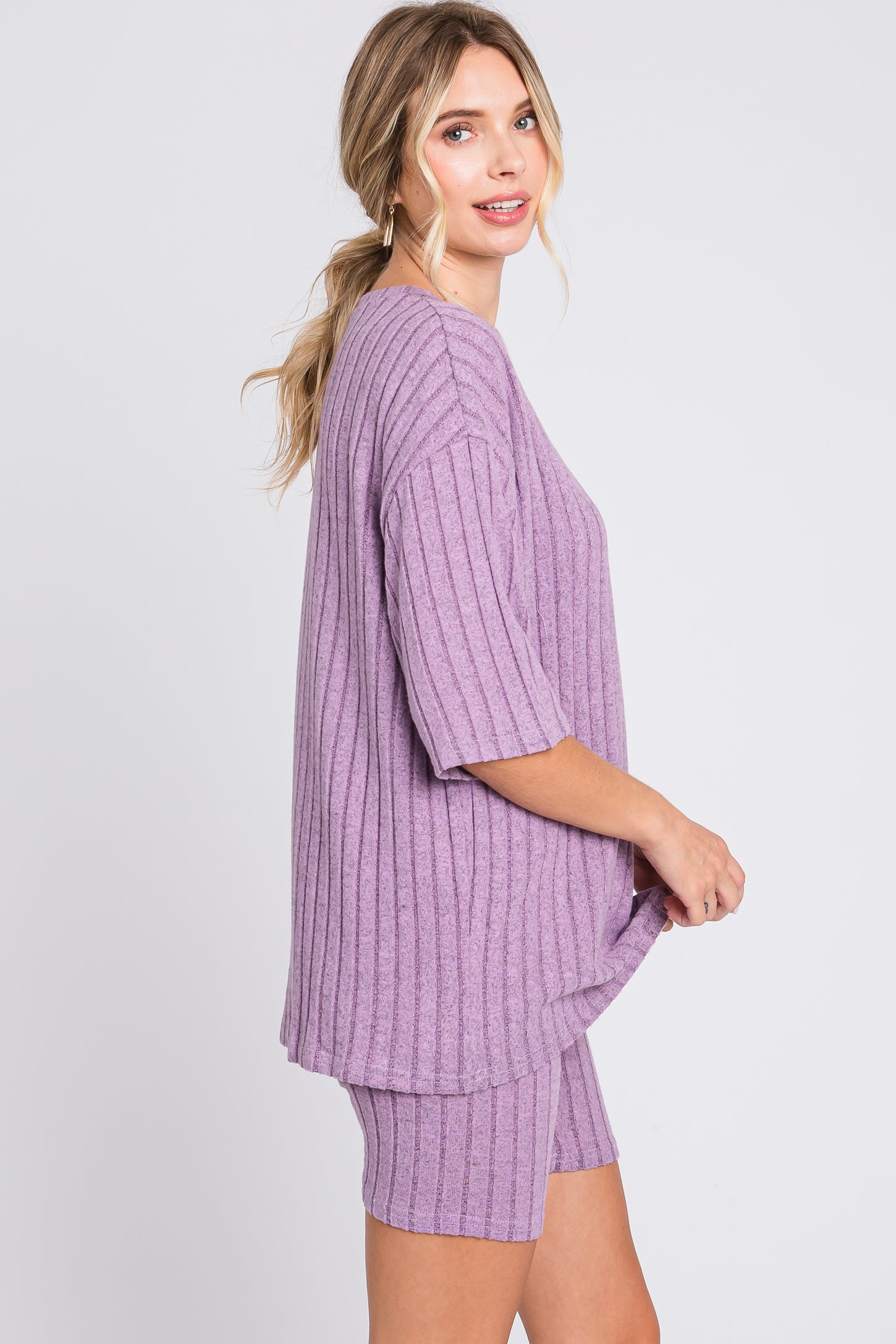 woman wearing a short-sleeve lavender ribbed loungewear set consisting of a top and shorts