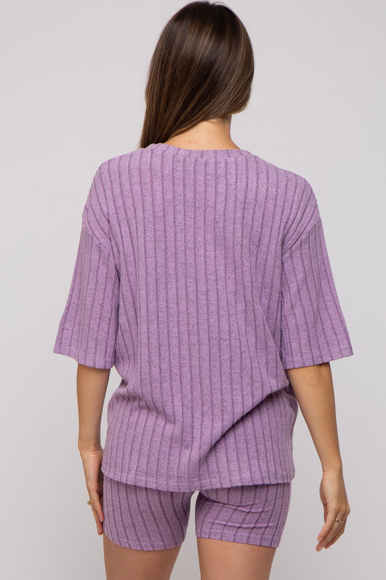 woman wearing a lavender maternity ribbed knit short set with a loose short sleeve top and matching shorts