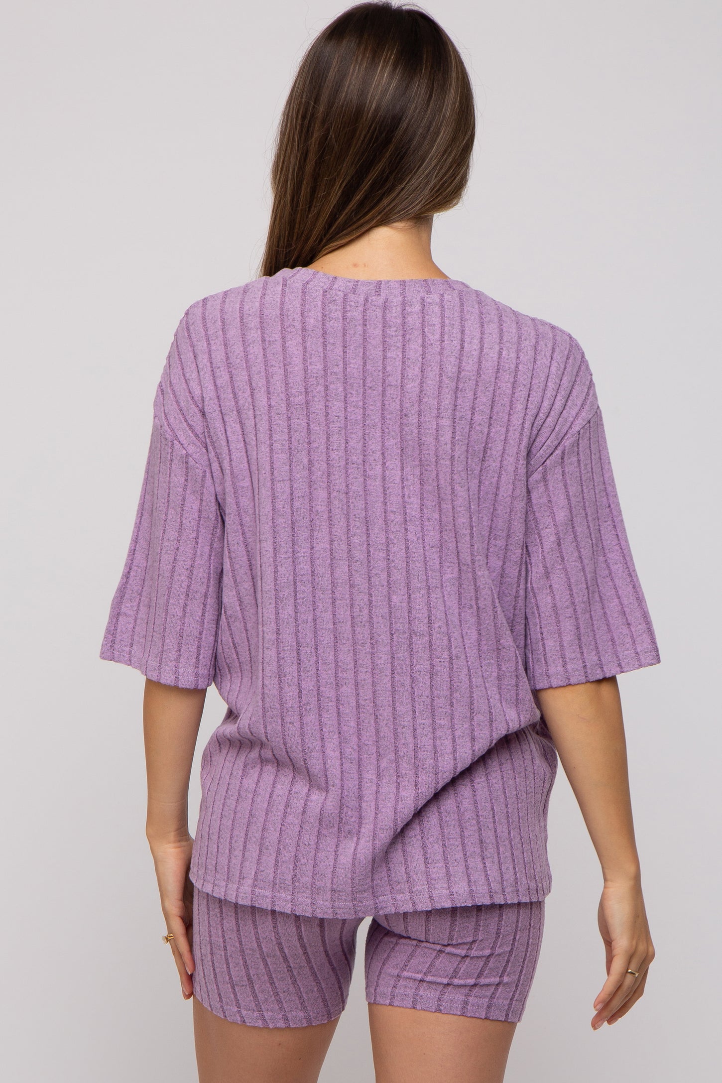 woman wearing a lavender maternity ribbed knit short set with a loose short sleeve top and matching shorts