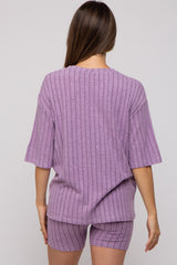 woman wearing a lavender maternity ribbed knit short set with a loose short sleeve top and matching shorts