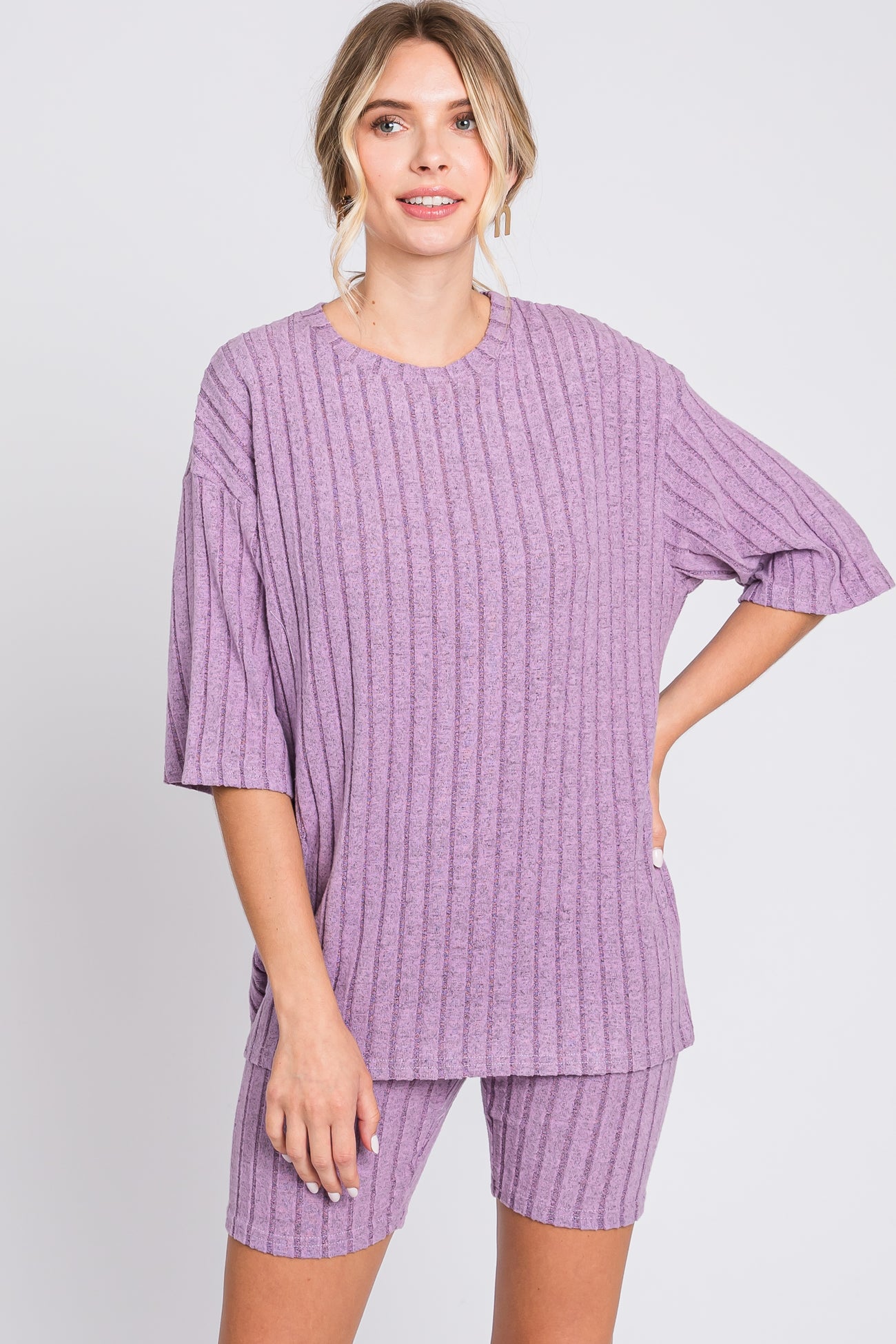 woman wearing a ribbed purple oversized t-shirt and matching shorts