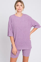 woman wearing a ribbed purple oversized t-shirt and matching shorts
