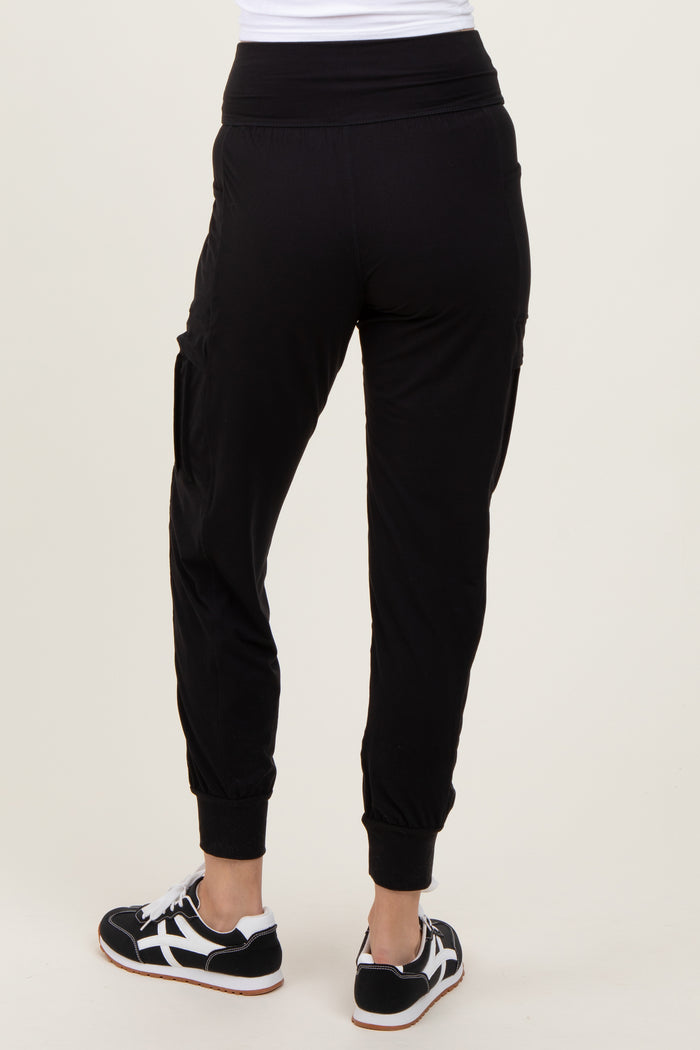 woman wearing black jogger pants with a relaxed fit and cropped cuffs, view from the back