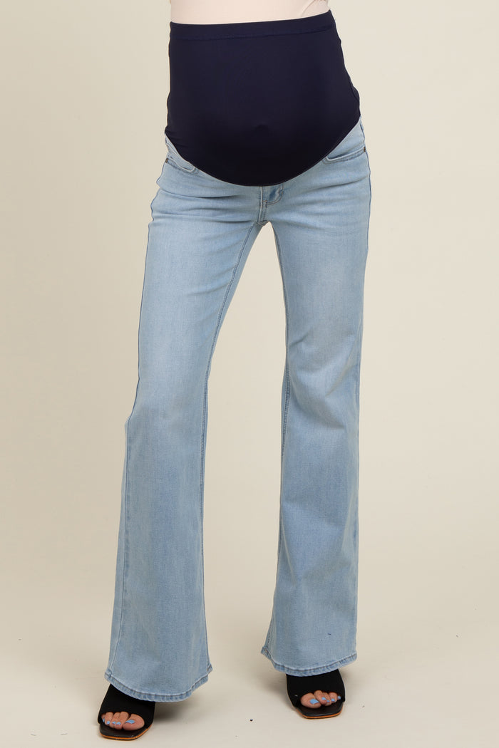maternity wear light blue flared jeans with a dark navy over-the-bump waistband