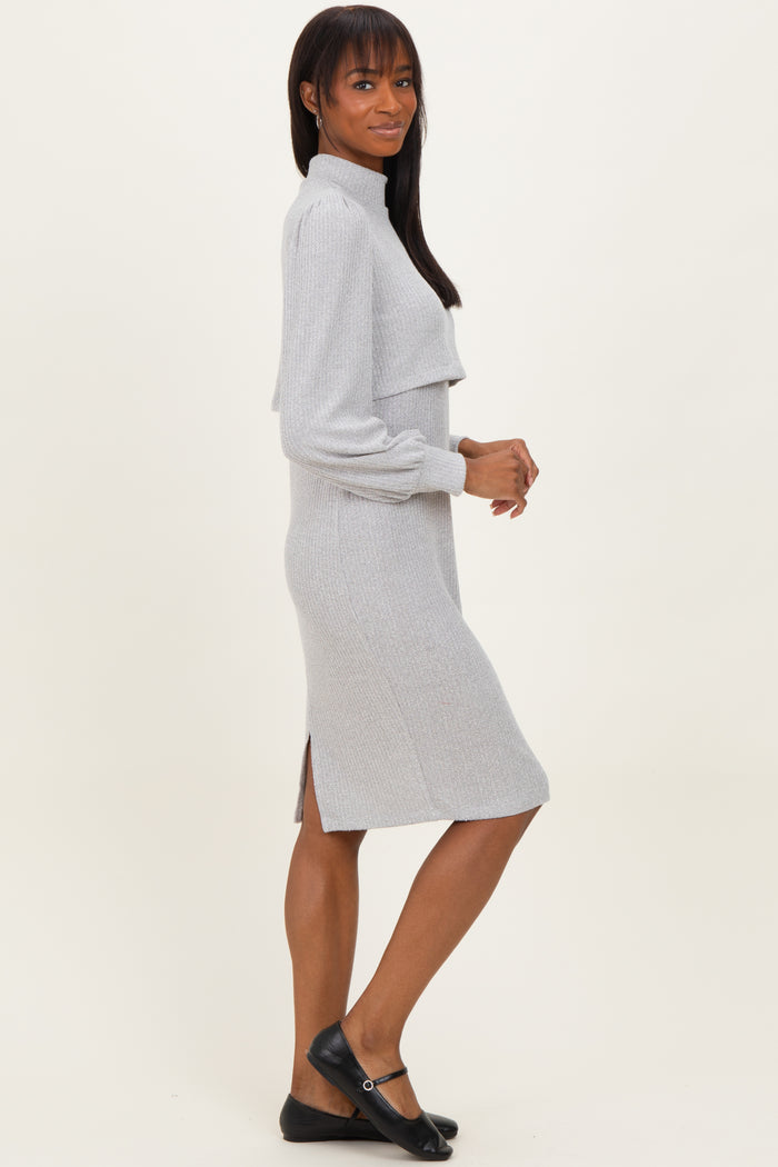 woman wearing a gray ribbed midi dress with a high neckline and side slits
