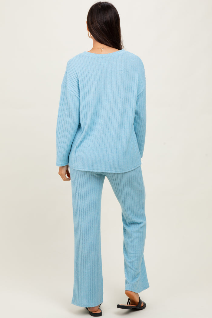woman wearing a light blue ribbed lounge set with a relaxed fit top and matching wide-leg pants