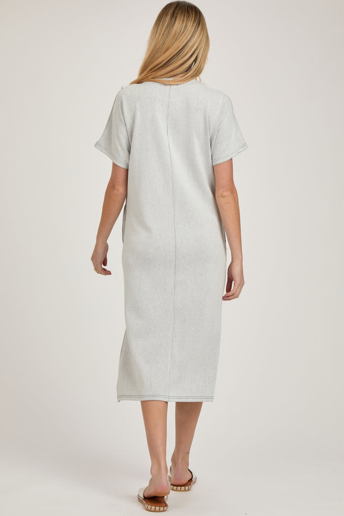 woman wearing a light gray maternity midi dress with short sleeves and a relaxed fit, view from the back