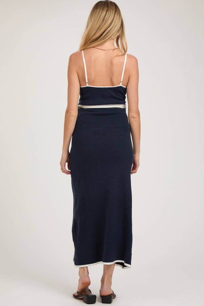 woman wearing a navy blue maternity maxi dress with a fitted bodice and a flowing skirt, seen from the back