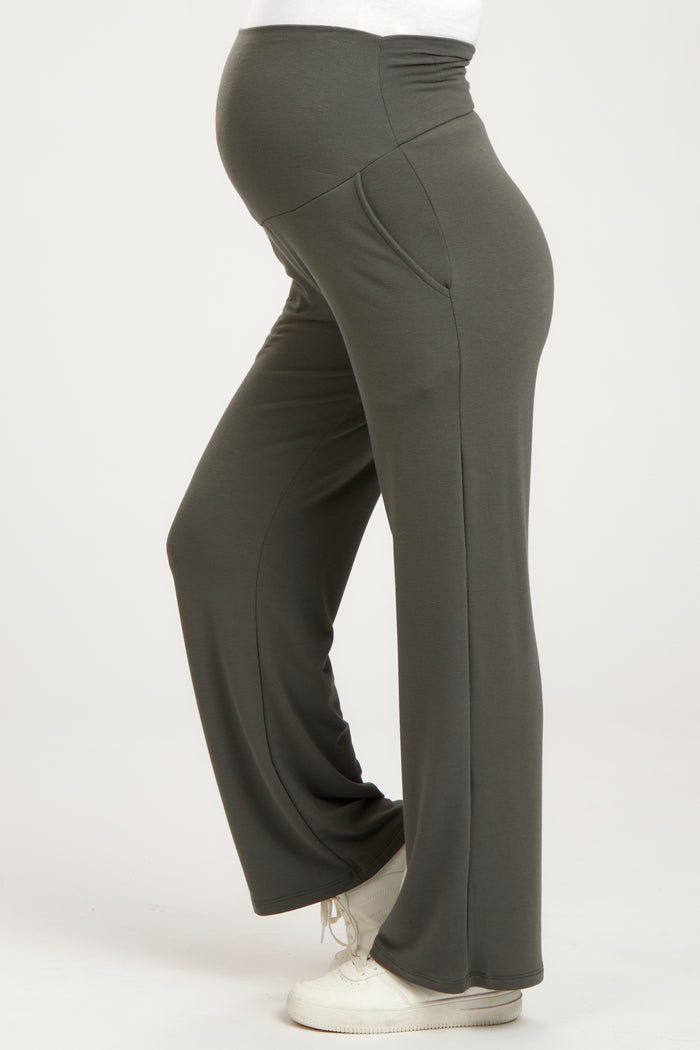 woman wearing dark gray maternity yoga pants with a fitted waist and wide legs, showing her baby bump