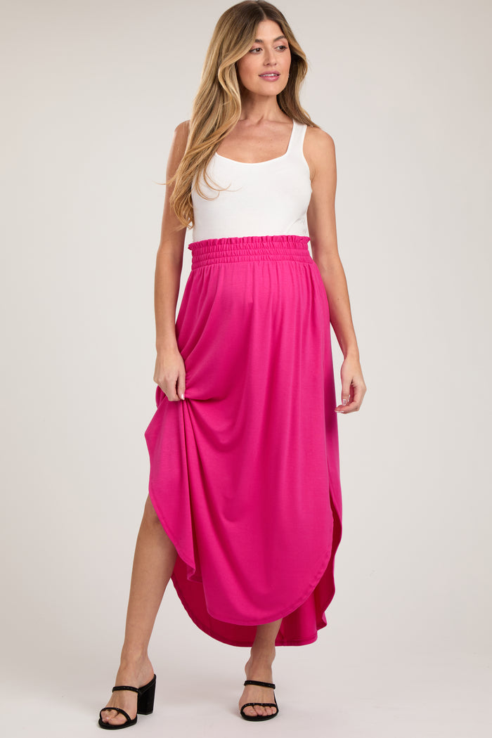 woman wearing a white tank top and a bright pink maxi maternity skirt with an elastic waistband
