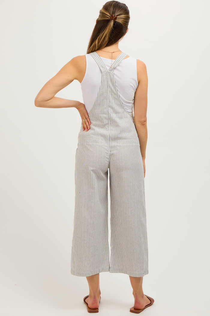 woman wearing a white striped maternity jumpsuit with wide legs and a fitted bodice, showing her back