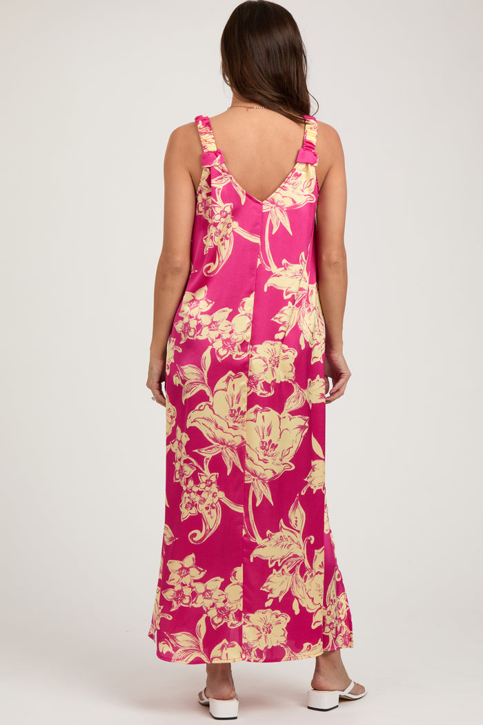 woman wearing a pink floral maternity maxi dress with ruffled straps and a relaxed fit, showcasing a baby bump