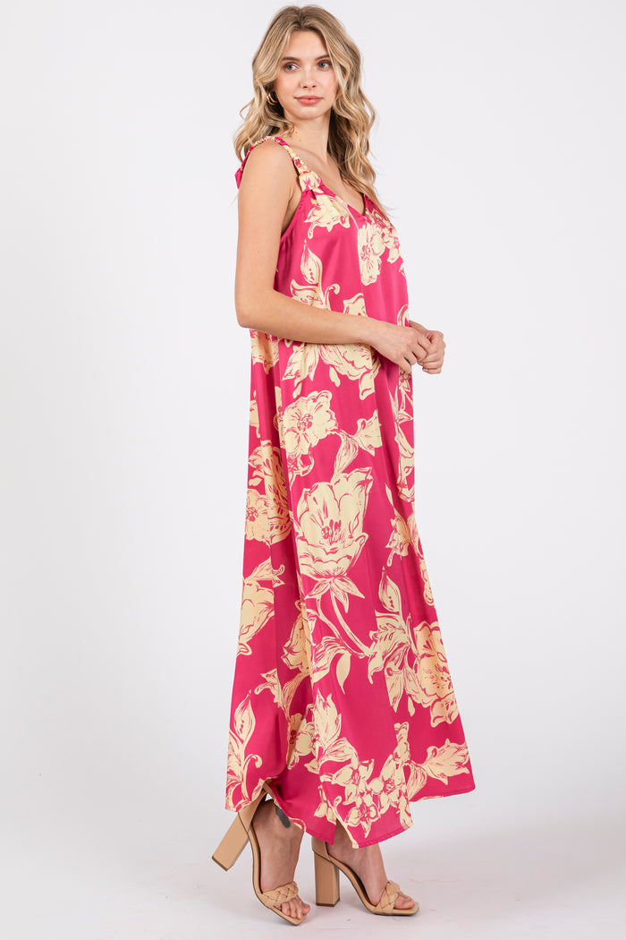 woman wearing a pink floral maxi dress with a V-neck and flowy silhouette