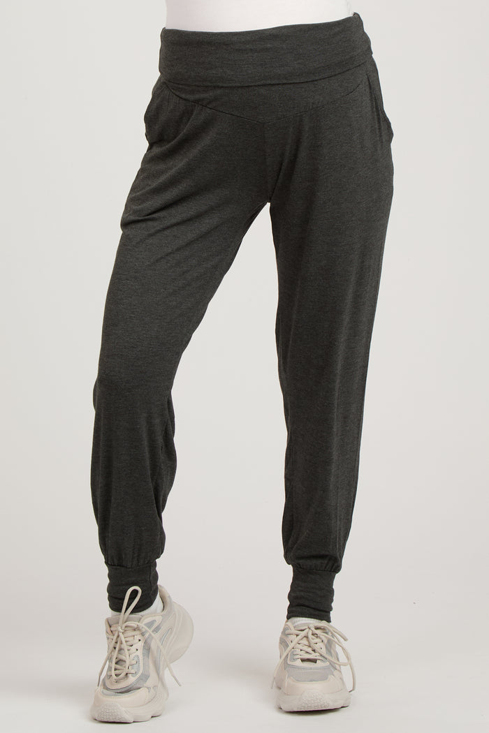 woman wearing dark gray maternity jogger pants with a wide waistband and gathered cuffs