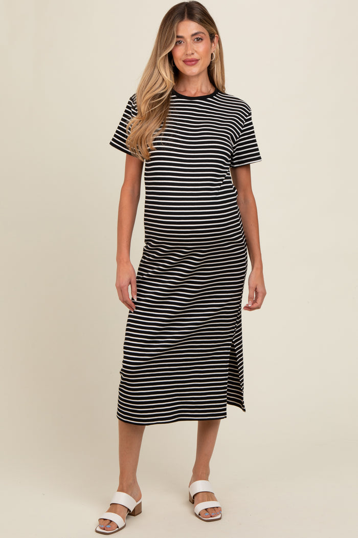 woman wearing a black and white striped maternity dress with a knee-length hem and short sleeves, showing her baby bump