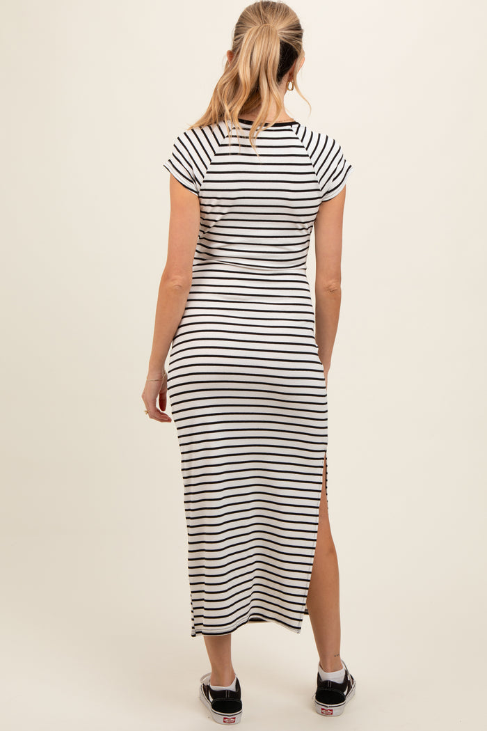 woman wearing a black and white striped maternity maxi dress with short sleeves and side slits