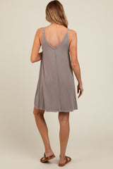 woman wearing a grey maternity sundress with a v-back and relaxed fit