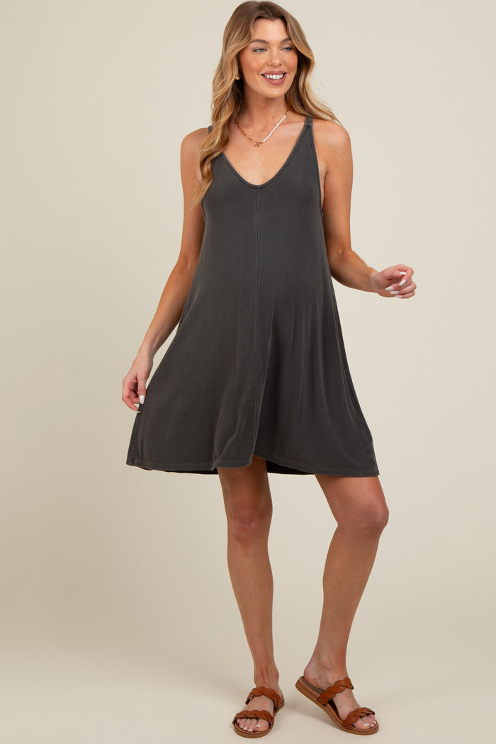 woman wearing a dark gray maternity swing dress with a v-neckline and relaxed fit, showcasing her baby bump