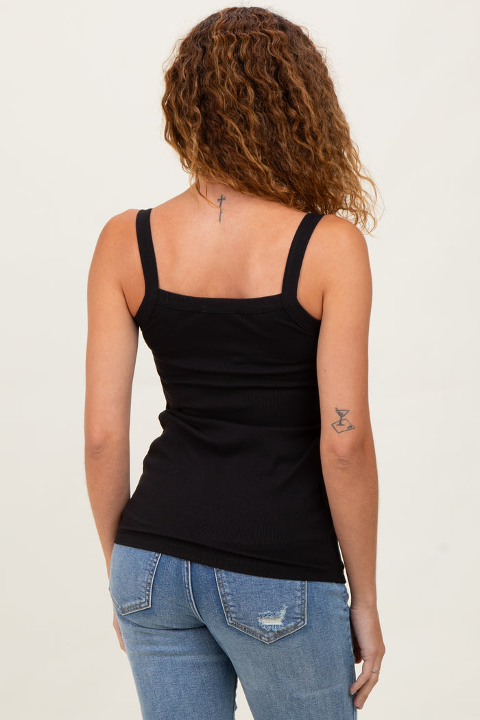woman wearing a black fitted tank top with spaghetti straps and light blue distressed jeans