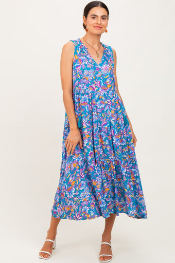 woman wearing a colorful floral print sleeveless midi dress with a tiered skirt and v-neckline