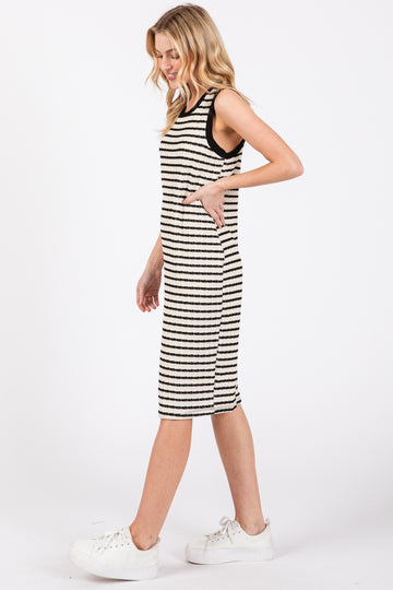 woman wearing a striped sleeveless midi dress with side pockets and white chunky sneakers