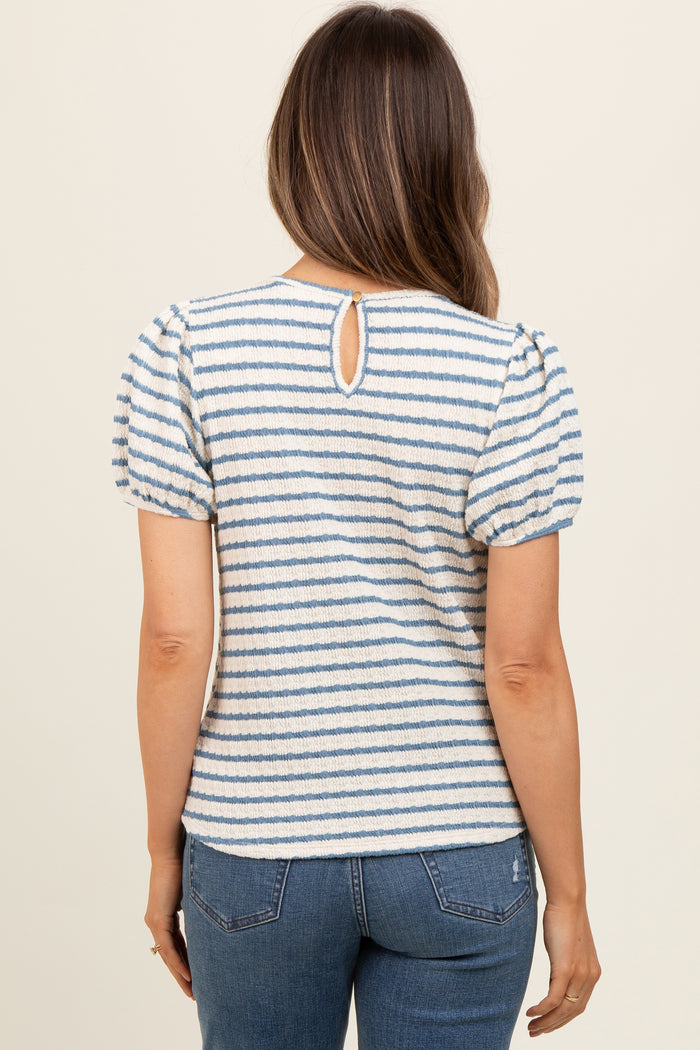 woman wearing a striped maternity top with puff sleeves and a keyhole back detail, viewed from the back