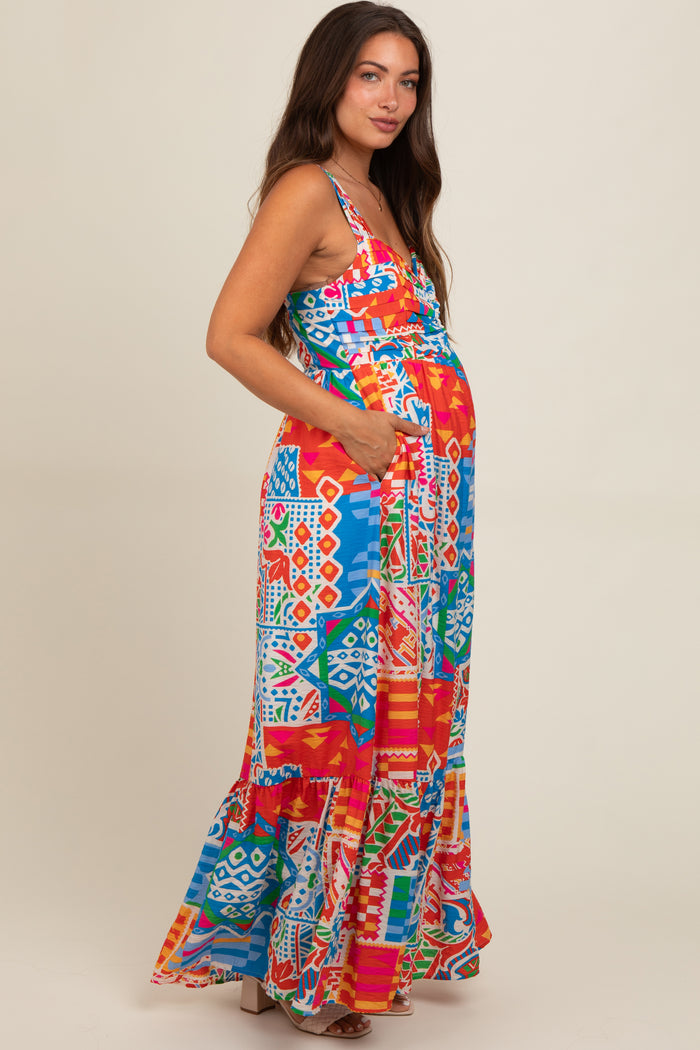 woman wearing a colorful patterned maternity maxi dress with pockets and a visible baby bump