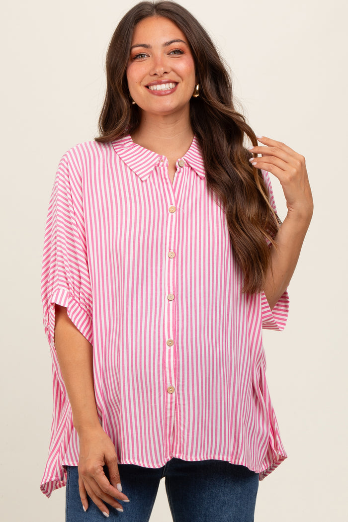 woman wearing a pink and white striped maternity top with buttons and loose sleeves, smiling at the camera