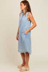 woman wearing a light blue sleeveless denim dress with pockets and frayed hem